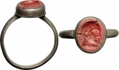 Silver ring, the bezel in glass paste with engraved face. Roman period, 2nd-3rd century AD. Size 19 mm.