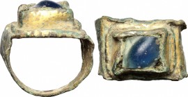 Gilded bronze ring with blue glass paste bezel. Migration period, 9th-10th century AD. Size 16.5 mm.