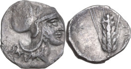 Greek Italy. Southern Lucania, Metapontum. AR Diobol, c. 325-275 BC. Obv. Helmated head of Athena right. Rev. Grain ear with leaf to right; cornucopia...