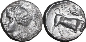 Greek Italy. Southern Lucania, Thurium. AR Stater, c. 350-300 BC. Obv. Helmeted head of Athena left, helmet decorated with Skylla pointing and holding...