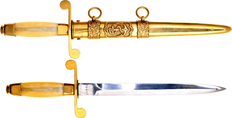 Gold-plated brass fittings. The handle is plastic. Brass scabbard with ornament,...