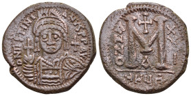 JUSTINIAN I (527-565).Antioch.Follis.

Obv : D N IVSTINIANVS P P A.
Helmeted and cuirassed bust facing, holding globus cruciger and shield; cross to r...