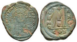 JUSTINIAN I.(527-565).Constantinople.Follis.

Obv : D N IVSTINIANVS P P AVC.
Helmeted, cuirassed bust facing, holding cross on globe and shield with h...