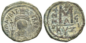 MAURICE TIBERIUS (582-602). Follis. Cyzicus.

Obv : D N ΜΑVRI TIЬЄR P P AV.
Helmeted and cuirassed bust facing, holding globus cruciger and shield dec...