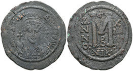 Justinian Æ Nummus. Constantinopolis, AD 527-565. D N IVSTINIANVS P P AVG, helmeted and cuirassed bust facing, holding globus cruciger and shield, a c...