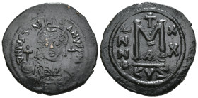 JUSTINIAN I (527-565). Follis.
Obv: D N IVSTINIANVS P P AVG.
Helmeted and cuirassed bust facing, holding globus cruciger and shield decorated with h...