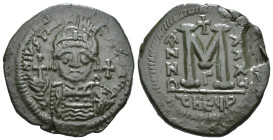 JUSTINIAN I (527-565). Follis.
Obv: D N IVSTINIANVS P P AVG.
Helmeted and cuirassed bust facing, holding globus cruciger and shield decorated with h...