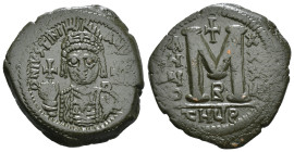 JUSTINIAN I (527-565). Follis.
Obv: D N IVSTINIANVS P P AVG.
Helmeted and cuirassed bust facing, holding globus cruciger and shield decorated with h...