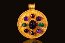 EARLY MEDIEVAL GOLD PENDANT WITH A CENTRAL AMETHYST CABOCHON

 Ca. AD 400 - 800 An Early Medieval gold circular pendant. The pendant has a large cen...