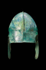 CHALCIDIAN BRONZE HELMET WITH CHEEK GUARDS

 Ca. 500 - 400 BC A Chalcidian helmet comprised of hammered tinned bronze. This helmet form, was initial...