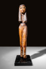 HUGE EGYPTIAN WOODEN STATUETTE OF WOMAN

 Late Period, Ca. 664 - 332 BC An Egyptian wooden statuette of a woman depicted wearing a wig with a wreath...