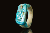 EGYPTIAN FAIENCE RING WITH HIEROGLYPHICS

 Third Intermediate Period, Ca. 750-654 BC An Egyptian bright blue faience finger ring with a flat bezel b...