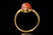 EGYPTIAN CARNELIAN SCARAB IN GOLD RING 

 Middle Kingdom, Ca. 2055 - 1790 BC An Egyptian carnelian heart scarab. The scarab a frilled clypeus, sinuo...