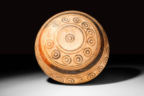 CYPRIOT POTTERY CUP WITH CIRCLES

 Ca. 900 - 700 BC A Cypriot bichrome cup decorated with a pattern of alternating coloured bands in red and brown o...