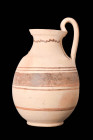 DAUNIAN POTTERY OLPE

 Ca. 600 - 500 BC A beautiful olpe featuring an elongated body, round mouth, and a high arching single handle. The body is dec...