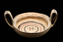 DAUNIAN KANTHAROS WITH STYLISED HUMAN FIGUREs

 Ca. 600 - 500 BC A Daunian bichrome pottery kantharos, featuring a wide, rounded bowl with two arche...