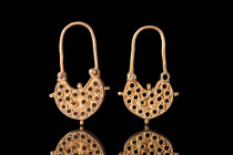 GREEK GOLD OPENWORK EARRINGS

 Ca. 700 - 500 BC A pair of Greek gold openwork lunar shape earrings composed of a main body decorated with gold threa...