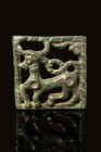 SCYTHIAN OPENWORK APPLIQUE WITH STAG

 Ca. 400 - 200 BC A Scythian bronze openwork plaquette depicting a stag. Most of its body is within a rectangu...
