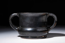 GREEK BLACK GLAZED KANTHAROS

 Ca. 450 - 400 BC A Greek black glazed Kantharos. The twin-handled cup has a tall, slightly flaring wall and a shallow...