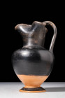GREEK BLACK GLAZED TREFOIL OINOCHOE

 Ca. 450 - 380 BC A Greek pottery black glaze oinochoe. Sitting upon a discoid foot, the vessel has a bulbous b...