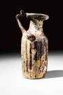 BYZANTINE RIBBED GLASS BOTTLE

 Ca. AD 400 - 600 A Byzantine purple/brown glass bottle. Its ribbed polygonal body was most likely mould-blown. The f...