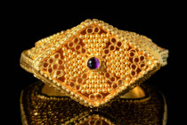 BYZANTINE OPENWORK BISHOP GOLD RING WITH CABOCHON

 Ca. AD 900 - 1200 A Byzantine openwork Bishop gold ring with a round hoop and a high bezel. The ...
