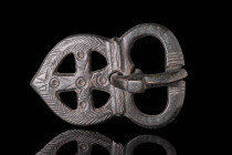 BYZANTINE BRONZE BUCKLE BELT WITH CROSS

 Ca. AD 500 - 700 A Byzantine bronze belt buckle with four openwork arms creating a cross. This is incised ...