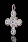 BYZANTINE BRONZE CROSS WITH THE 5 WOUNDS OF CHRIST

 Ca. AD 800 - 1000 A Byzantine bronze cross-shaped pendant decorated with moulded five dots/circ...
