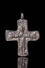 BYZANTINE BRONZE CROSS PENDANT WITH CRUCIFIXION

 Ca. AD 800 - 1000 A Byzantine bronze cross-shaped pendant decorated with Christ crucifixion, frame...