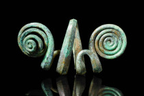 HALLSTATT BRONZE BRACELET WITH SPIRALS

 Ca. 800 - 600 BC A Hallstatt bronze bracelet with a double spiral design formed from a single elongated str...