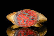 SASANIAN GOLD RING WITH CARNELIAN INSCRIBED INTAGLIO

 Ca. AD 400 - 600 A Sasanian gold ring with a round hoop widening to form a bezel securing a c...