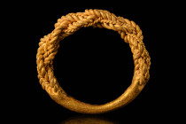 VIKING GOLD RING WITH TWISTED THREADS

 Ca. AD 800 - 1100 A Viking gold ring made of twisted and braided gold wires of different dimensions that tap...