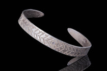 VIKING SILVER BRACELET WITH STAMPED GEOMETRIC MOTIF

 Ca. AD 800 - 1100 A Viking hammered silver bracelet of circular form with tapering and polishe...