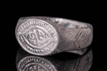 VIKING AGE SILVER RING WITH ALMOND SHAPED BEZEL

 Ca. AD 900 - 1100 A Viking silver ring with an wide flat band. The exterior is convex and decorate...