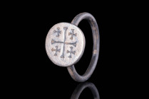 MEDIEVAL SILVER RING WITH JERUSALEM SYMBOL

 Ca. AD 1100 - 1300 A Medieval silver ring with a slender band and a circular bezel is carved with a fou...