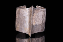 SELJUK SILVER BRACELET WITH ROSETTE MOTIF

 Ca. AD 1000 - 1300 A silver Seljuk penannular bracelet with a central ridge with two opposing decorated ...
