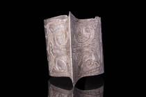 SELJUK SILVER BRACELET WITH STYLISED KUFIC LETTERS

 Ca. AD 1000 - 1300 A silver Seljuk penannular bracelet with a central ridge with two opposing d...