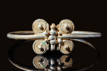 SELJUK SILVER BRACELET WITH FOUR SPIRALS

 Ca. AD 900 - 1100 A stunning Seljuk silver bracelet with finials comprising two spirals and central silve...