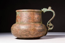 TIMURID COPPER ALLOY JUG WITH DRAGON SHAPED HANDLE

 Ca. AD 1450 - 1550 A Timurid copper alloy Jug with a dragon handle. It has a globular body embe...