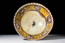 NISHAPUR GLAZED BOWL WITH FLORAL DECORATION

 Ca. AD 900 - 1000 A Nishapur glazed pottery bowl featuring a deep basin and convex walls painted with ...