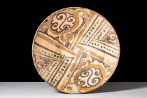 NISHAPUR GLAZED BOWL WITH GEOMETRIC CENTRAL MOTIF

 Ca. AD 900 - 1000 A Nishapur glazed pottery bowl featuring a deep basin and convex walls painted...