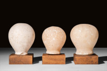 GROUP OF THREE NEAR EASTERN MARBLE MACES 

 Ca. 3rd-2nd Millennium BC A group of three marble mace heads, each featuring a piriform body and a lengt...