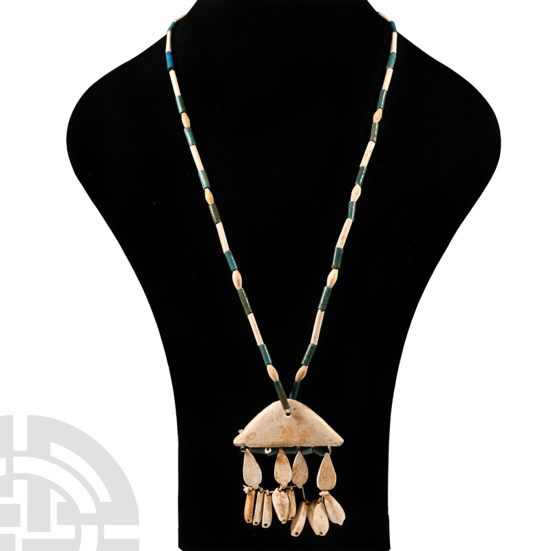 1400-1100 B.C.. Alternating white and turquoise tubular beads with oval spacer b...