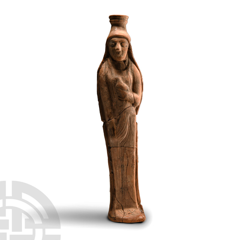 Archaic, 6th century B.C.. The free-standing perfume vase modelled as a standing...