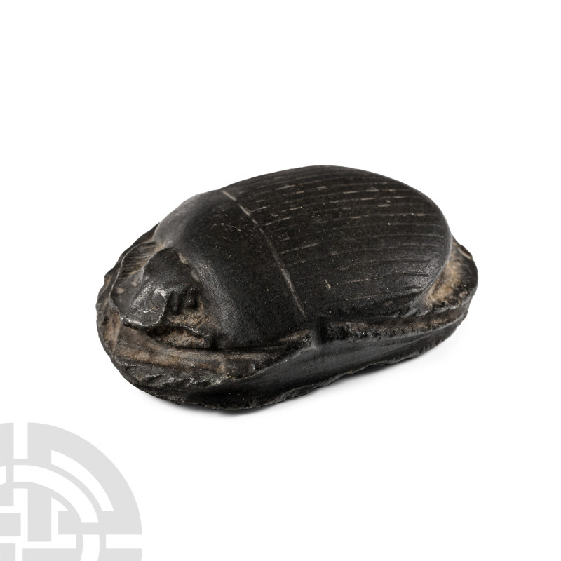 Late Period, 664-332 B.C.. Black hardstone scarab with finely carved head, eyes,...