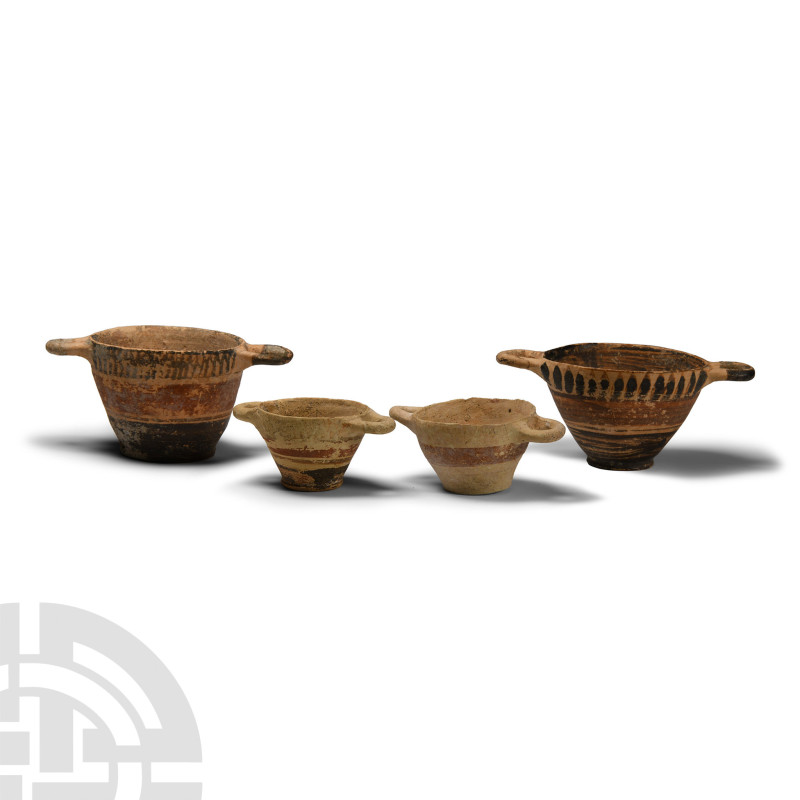 6th century B.C.. Group of four graduated ceramic cups, each with two loop handl...