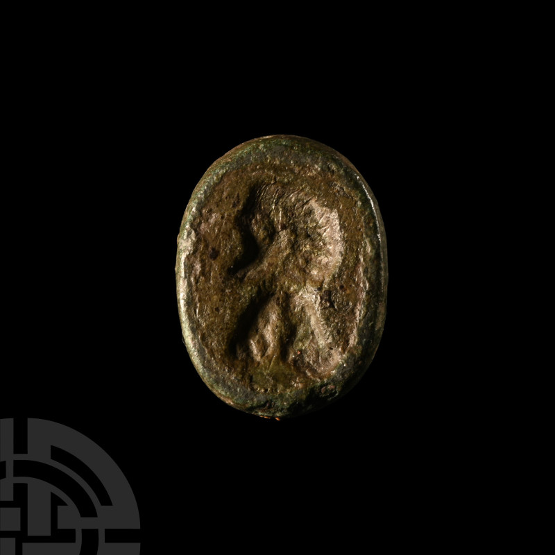 Circa 2nd century A.D.. Ellipsoid glass insert with profile portrait bust to one...