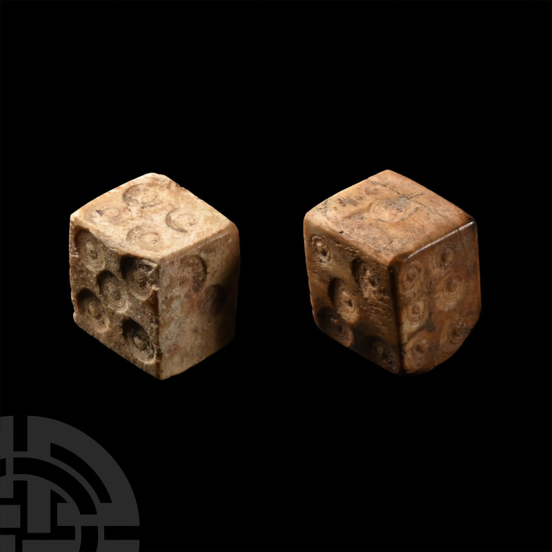 2nd-4th century A.D.. Two roughly cuboid dice with ring and dot markings dispose...