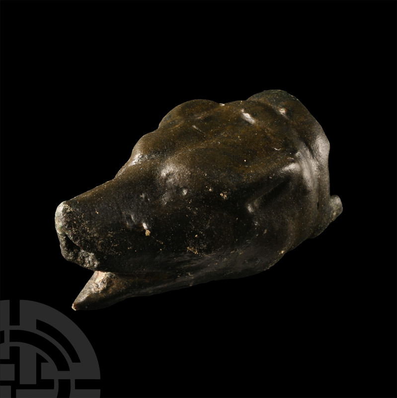 1st-2nd century A.D.. Hollow-formed with acute lower jaw, triangular muzzle, gus...