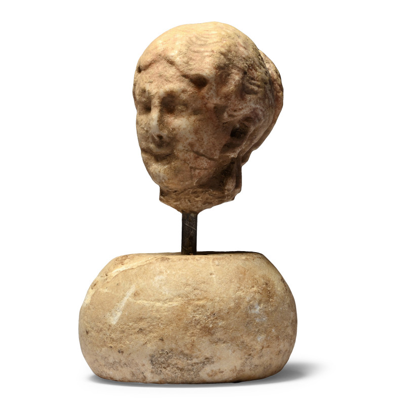 2nd century A.D. or later. Carved in the round with detailed hairstyle comprisin...